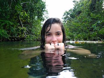 Portrait of teenage girl swimming in lake