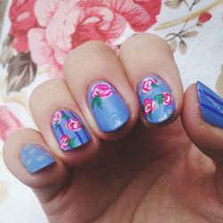 Cropped image of woman showing nail art