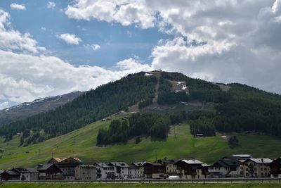 Houses on mountain against sky