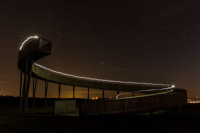 Low angle view of illuminated building against sky at night