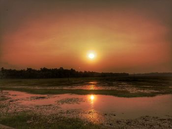 Scenic view of lake against sky during sunset