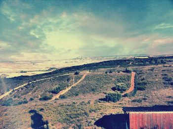 Scenic view of landscape against cloudy sky