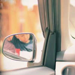 Portrait of man seen through car window