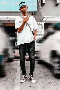 Full length portrait of young man standing on bus