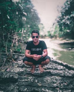 Portrait of young man sitting outdoors