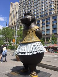 Statue against buildings in city
