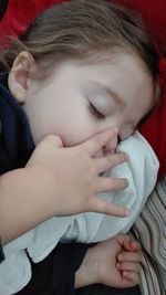 Close-up of baby lying on hand