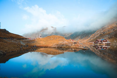 Scenic view of lake against cloudy sky