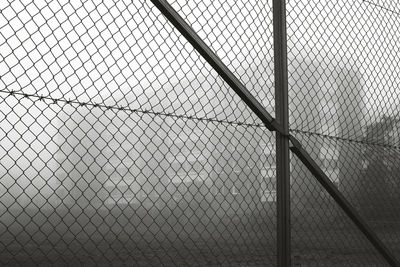 Close-up of chainlink fence during foggy weather