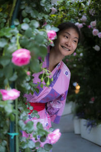 Smiling woman behind flowering plants