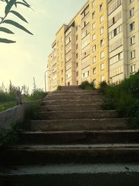 Low angle view of staircase by building against sky