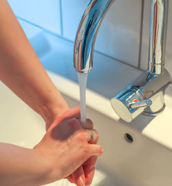 Midsection of woman in bathroom at home