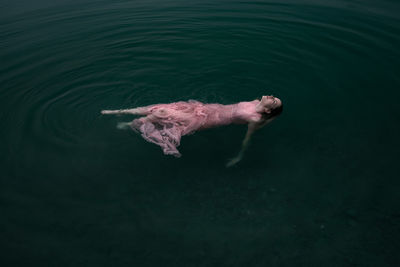 High angle view of woman swimming in lake