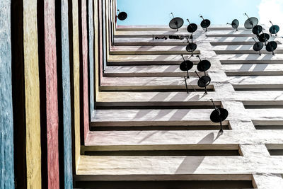 Low angle view of antenna mounted on wall against sky