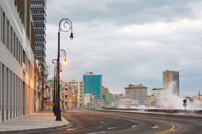 Street amidst buildings against sky