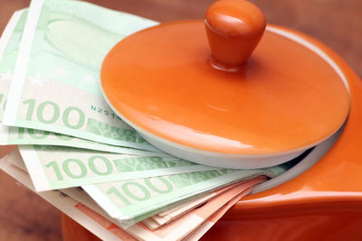 Close-up of currency in cup on table