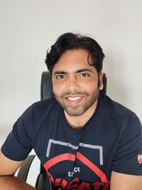 Portrait of young man against white background