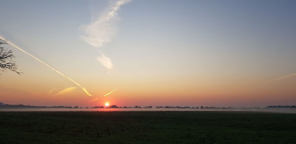 Scenic view of field against sky during sunset