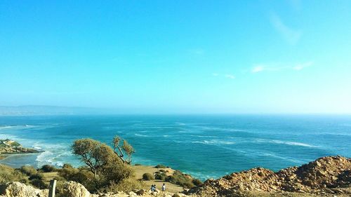 Scenic view of sea against clear blue sky