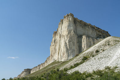 White chalk limestone rock against a blue sky aerial view