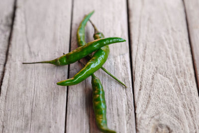 Close-up of green chili peppers on table