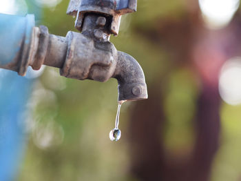 Close-up of water faucet against blurred background