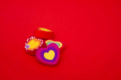 Close-up of heart shape over colored background