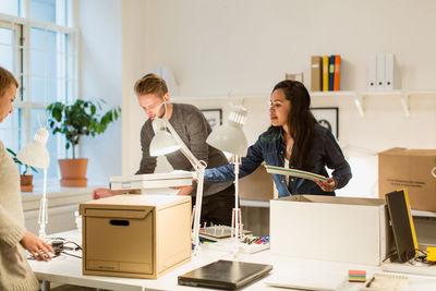 Multi-ethnic business colleagues working at illuminated creative office