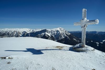 Scenic view of snowcapped mountains against blue sky