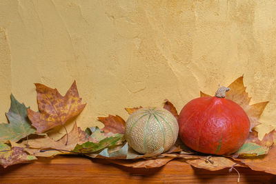 Close-up of fruits on table against wall