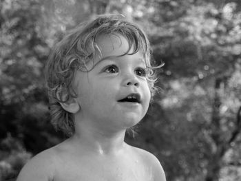 Close-up portrait of boy looking away outdoors