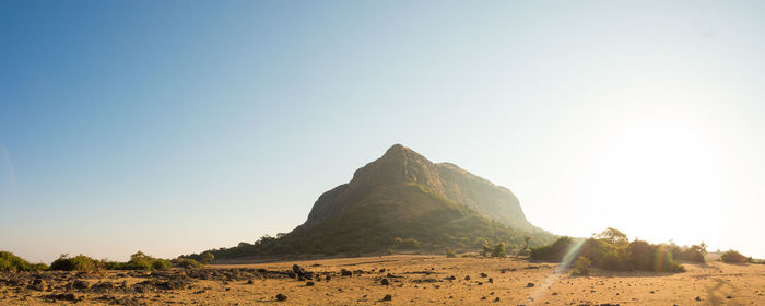 Panoramic view of arid landscape against clear sky