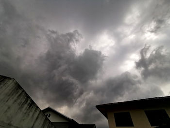 Low angle view of building against cloudy sky