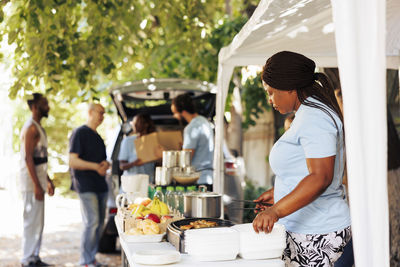 Rear view of man holding food at home