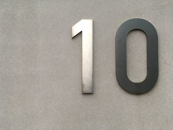 Metallic number 10 on concrete wall