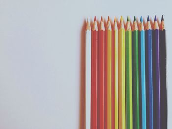 Close-up of colored pencils against white background