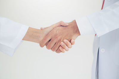 Midsection of doctors shaking hands