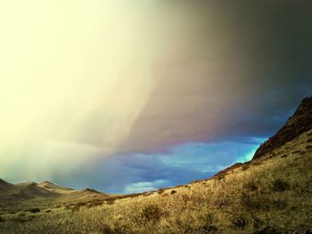 Scenic view of landscape against cloudy sky