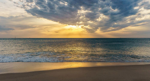 Scenic view of sea against sky at sunset