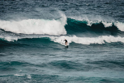 Man surfing waves in atlantic ocean, tenerife, spain