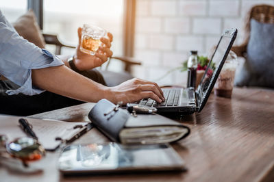 Midsection of woman working on table