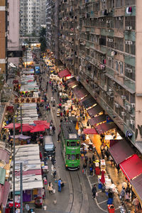 High angle view of people on city street amidst buildings