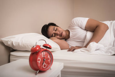 Young woman lying on bed at home