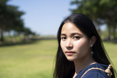 Portrait of beautiful woman on field