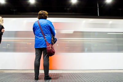 Rear view of people on train at railroad station platform