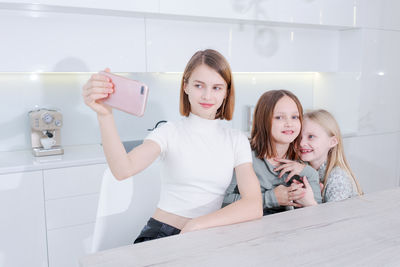 Portrait of young woman using mobile phone in bathroom