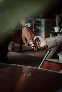 Close-up of woman sitting on table