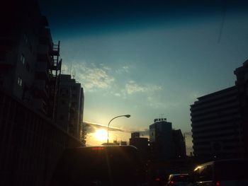 Buildings in city at sunset