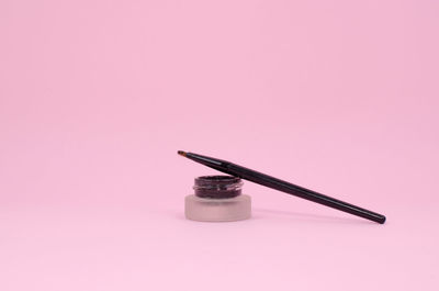 High angle view of electric lamp on table against pink background