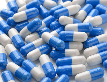 Blue capsules on white background